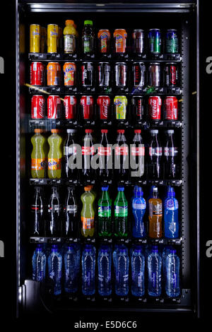 Various brands of refreshing non-alcoholic soft drinks, coke, lemonades and water on display in automatic vending machine Stock Photo