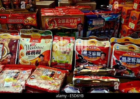 JIU CHI TOWN (SICHUAN), CHINA:  A wide variety of pre-packaged food products on display at a food shop Stock Photo