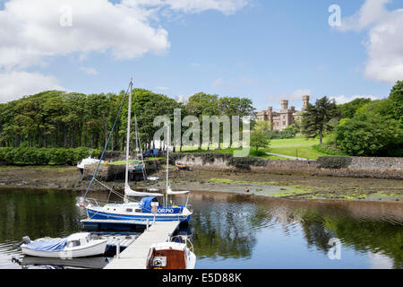 Lews castle from across harbour with moored boats in Stornoway Isle of Lewis Outer Hebrides Western Isles Scotland UK Britain Stock Photo