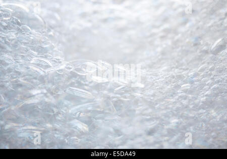 Close up of white foamy bath bubbles with soft texture and shallow depth of field. No people. Stock Photo