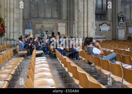 Visitors sitting inside the magnificent Canterbury Cathedral, England, UK Stock Photo