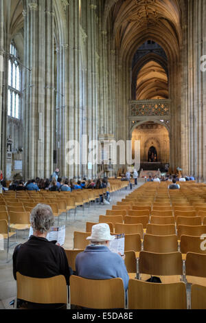 Visitors sitting inside the magnificent Canterbury Cathedral, England, UK Stock Photo