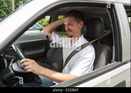 Young caucasian driver is thinking about a problem Stock Photo