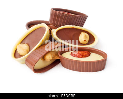 An assortment of fine chocolates in white, dark and milk chocolate with nuts on white background Stock Photo