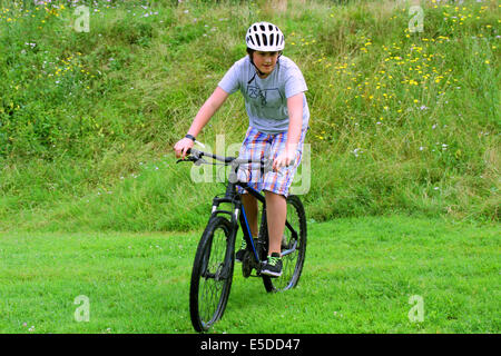 Teenage boy riding on the bike in the park Stock Photo