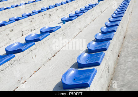 rows of empty blue stadium seats Stock Photo