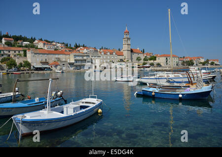 Fishing boats in the harbour in front of the church of Sveti Ivan, St Ivan, Sutivan, Island of Brač, Dalmatia, Croatia Stock Photo