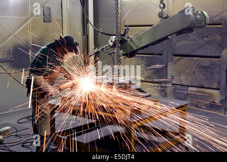 Working with grinding machine in a foundry Stock Photo