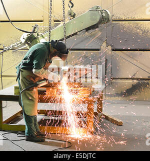 Working with grinding machine in a foundry Stock Photo