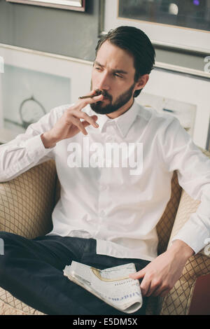 Portrait of young man smoking cigarillo Stock Photo