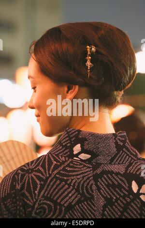 Young Japanese woman in a traditional kimono at a summer festival Stock Photo