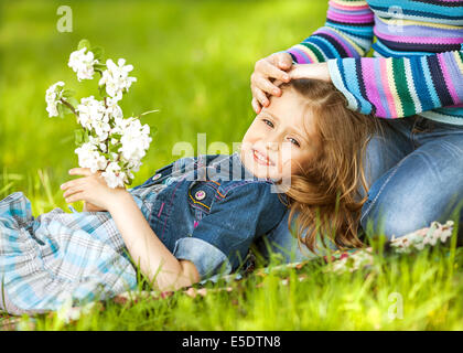 Happy mother and daughter laughing together outdoors Stock Photo