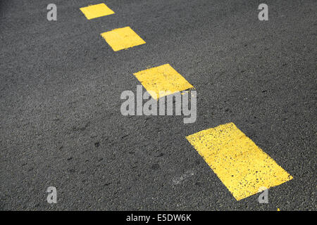Pedestrian crossing road marking, yellow striped lines on asphalt Stock Photo