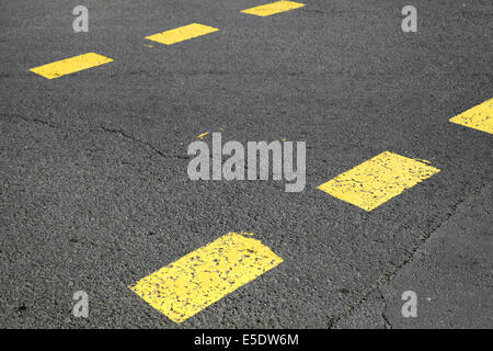 Pedestrian crossing road marking with yellow striped lines on asphalt Stock Photo