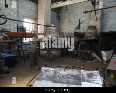 Two men working in the forge of National Waterways Boat Museum Ellesmere Port Cheshire home to nation's collection Canal river waterway history Stock Photo