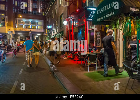 amsterdam, Holland, The Netherlands, Large Crowd People, Young Tourists teenagers Visiting on Town Square, Street Scene, at night, Stock Photo