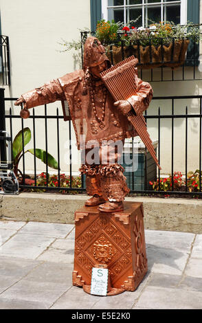 QUEBEC CITY, CANADA - JULY, 20: Inca street performer in copper statue costume playing pan flute in Old Quebec city, Canada on J Stock Photo