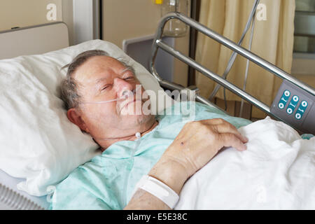 Portrait of sick old man in hospital bed Stock Photo