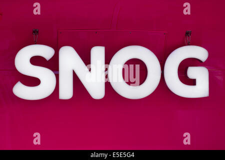 Bight illuminated SNOG logo sign.  Hanging on a novelty double decker bus selling frozen yogurt along the Embankment, London, near Waterloo Bridge. Stock Photo