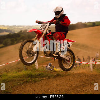 Motocross rider doing jumps Stock Photo