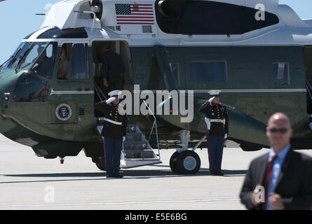 July 23, 2014 - Los Angeles, California, U.S - Marine One --- US Marines from HMX-1 continue their salute as President Barack Obama boards Marine One at LAX on Wednesday July 23, 2014.  Sikorsky's SH-3 Sea King helicopter has been in use by the US Marine Corps' HMX-1 squadron as the first choice for Marine One since not long after it was placed in service by the US Navy in 1961.  The familiar metallic green with white top Sea King is transported, along with the presidential limousine and other large equipment via a set of several C-17 Boeing Globemaster transport aircraft operated by the US Ai Stock Photo