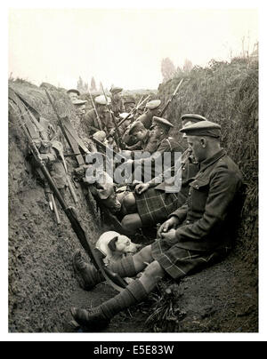 Historic image of WW1 Highland territorials and their mascot dog wait to 'go over the top' in a trench in Northern France Stock Photo