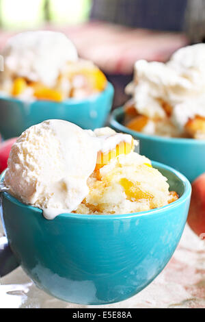 Peach cobbler served with vanilla ice cream. Stock Photo