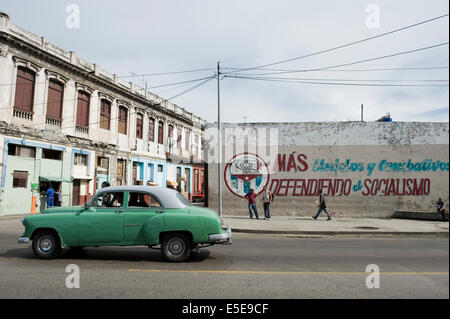 Street scene of Havana Cuba with the classic American car and communism graffiti slogans Stock Photo