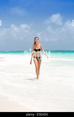 A beautiful young woman in a bikini on a beach Stock Photo