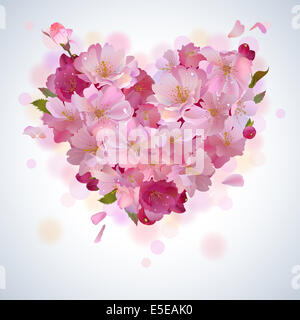 Spring background with gentle heart from cherry flowers and petals Stock Photo