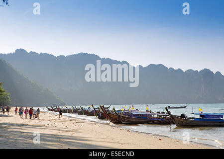 Travelers arriving on Ao Nang beach by Long Tail boat, Krabi, Thailand Stock Photo