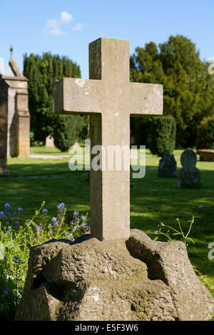 Cross in graveyard on a gravestone in a village churchyard, England, UK Stock Photo