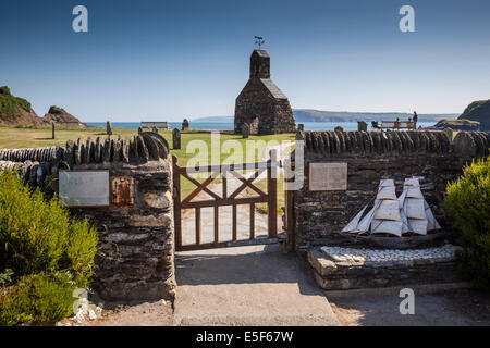 Ruins of the Church of St. Brynach the Abbot, with plaque and ship model at Cwm-yr-Eglwys, DInas Head, Pembrokeshire, Wales Stock Photo