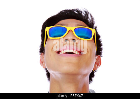 Happy asian man in yellow sunglasses looking up Stock Photo