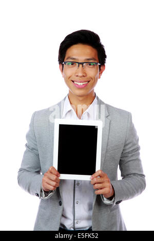 Smiling asian man showing tablet computer screen over white background Stock Photo