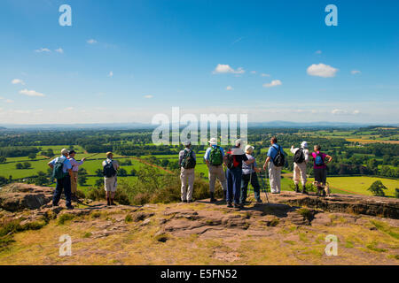 A group of walkers look out over North Shropshire countryside from Grinshill Hill, Shropshire, England Stock Photo