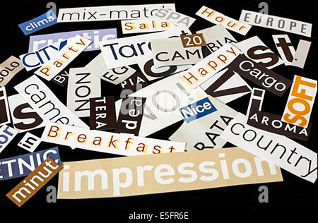 Words clipped from magazines on black background. Stock Photo