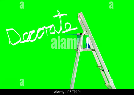 Decorate written on a green wall with a stepladder,a tin of paint and a paintbrush Stock Photo