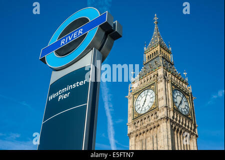Sign of the Westminster pier ferries stop on the river Thames in London, UK. On the background the Big Ben tower. Stock Photo