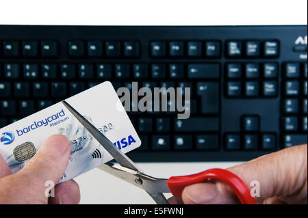 Adult male cutting credit card up. Stock Photo