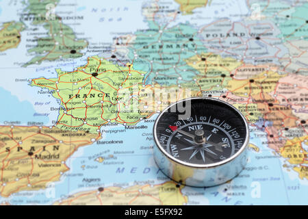 Compass on a map pointing at France and planning a travel destination Stock Photo