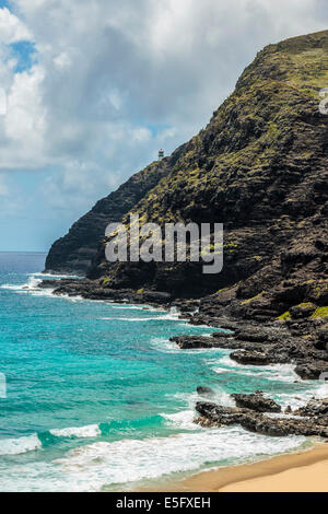 The coast of Makapuu Point with a view of Makapuu lighthouse from the beach on Windward Oahu, Hawaii Stock Photo