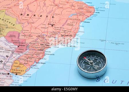 Compass on a map pointing at Brazil and planning a travel destination Stock Photo