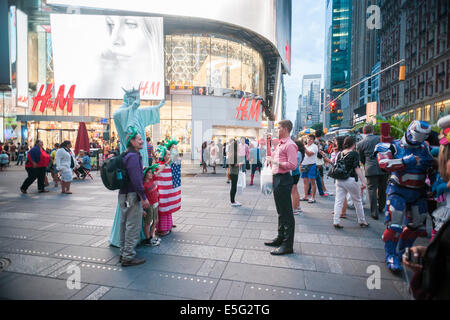 Costumed characters swarm Times Square in New York begging for tips Stock Photo