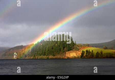 Rainbow highlights the gothic Straining Tower on Lake Vyrnwy (Victorian reservoir) Montgomeryshire, Powys, Wales, UK Stock Photo
