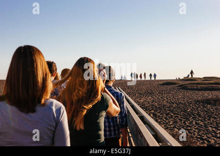 Back view of people walking in line Stock Photo