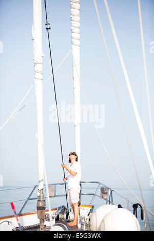 Woman pulling rope on sailboat Stock Photo