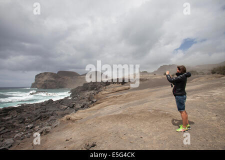 Woman taking photo of beach Stock Photo