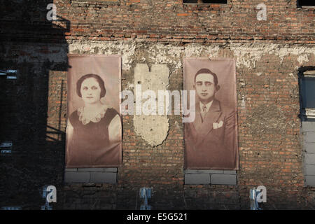 Images of former Jewish inhabitants of the Warsaw Ghetto cover the walls at Prozna Street in Warsaw Stock Photo