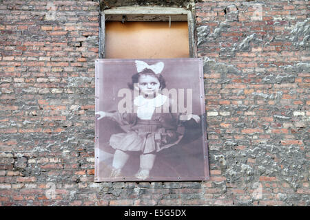 Images of former Jewish inhabitants of the Warsaw Ghetto cover the walls at Prozna Street in Warsaw Stock Photo